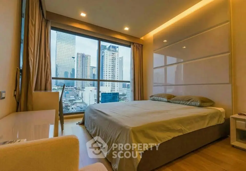 Luxurious bedroom with stunning city view and modern design in high-rise apartment.