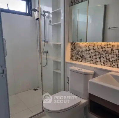 Modern bathroom with glass shower and stylish tile backsplash