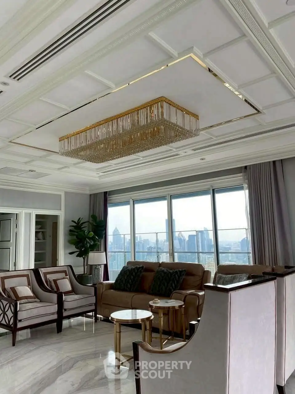 Luxurious living room with elegant chandelier and stunning city view