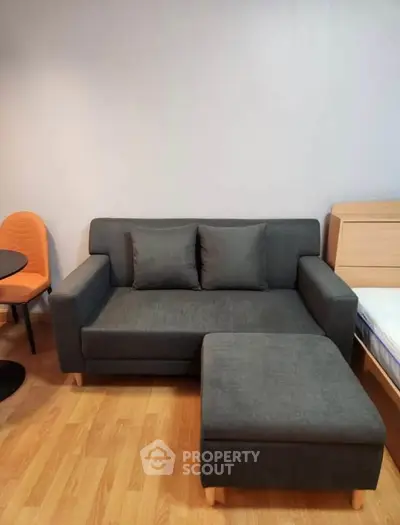 Cozy living room with modern gray sofa and wooden flooring