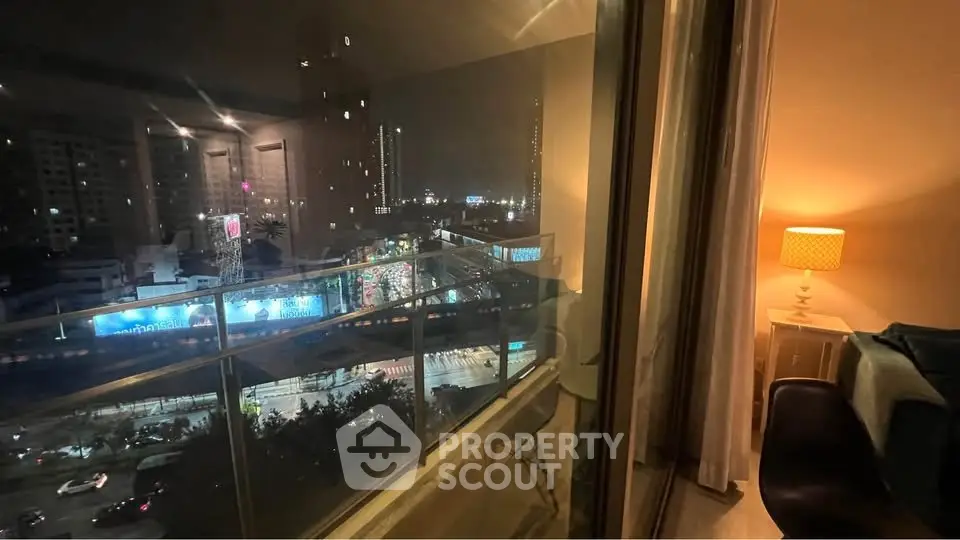 Stunning city view from a cozy apartment balcony at night, perfect for urban living.