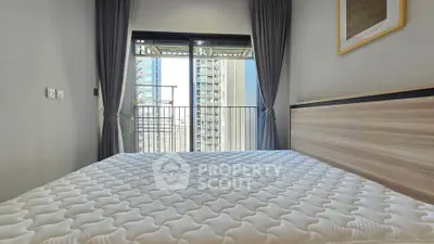 Modern bedroom with city view and large window, featuring a comfortable bed and stylish decor.