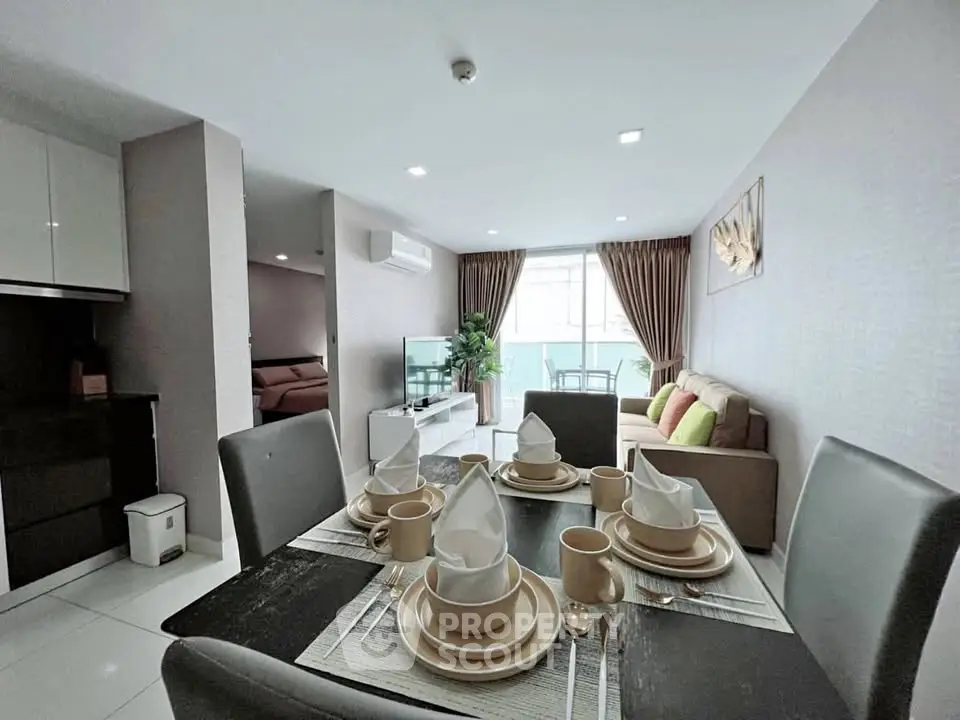 Modern living room with elegant dining setup and cozy seating area