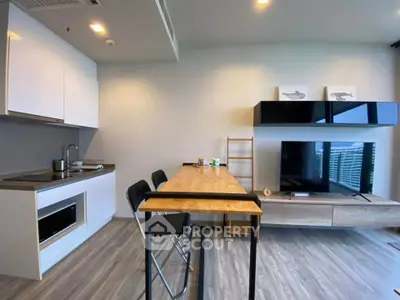 Modern living room with open kitchen, sleek furniture, and stylish decor