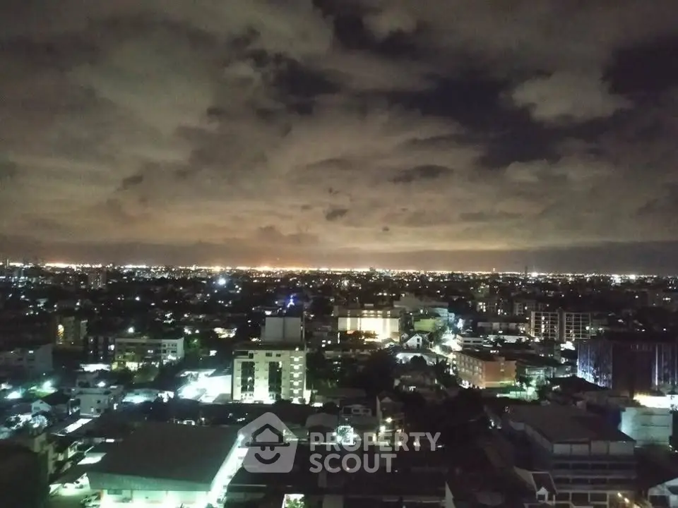 Stunning cityscape view at night showcasing vibrant urban lights and expansive skyline.