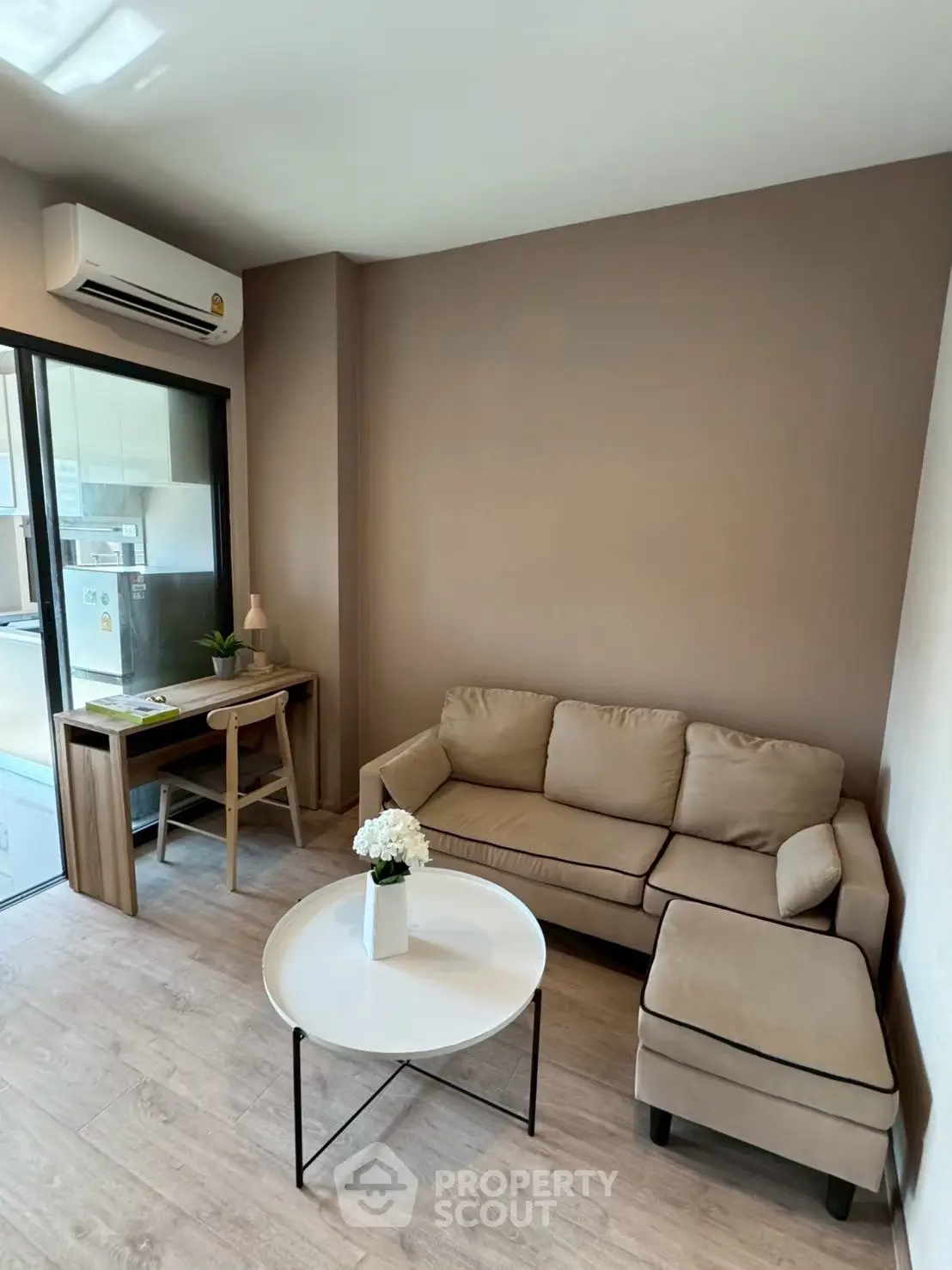 Cozy living room with modern furniture and natural light in a stylish apartment.