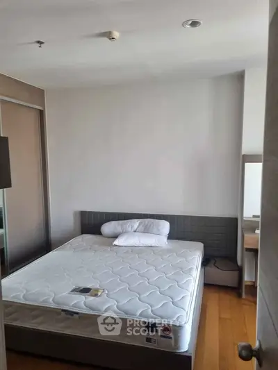 Cozy bedroom with modern furnishings and ample natural light, perfect for relaxation and comfort.