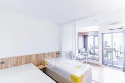 Bright modern bedroom with two beds and city view balcony