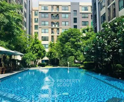 Luxurious residential building with a sparkling pool and lush greenery
