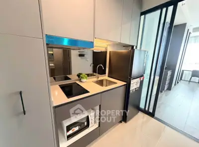 Modern kitchen with sleek appliances and open layout in stylish apartment