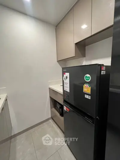 Modern kitchen with sleek cabinets and a new refrigerator, perfect for contemporary living.