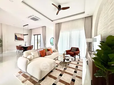 Luxurious modern living room with elegant decor and large windows