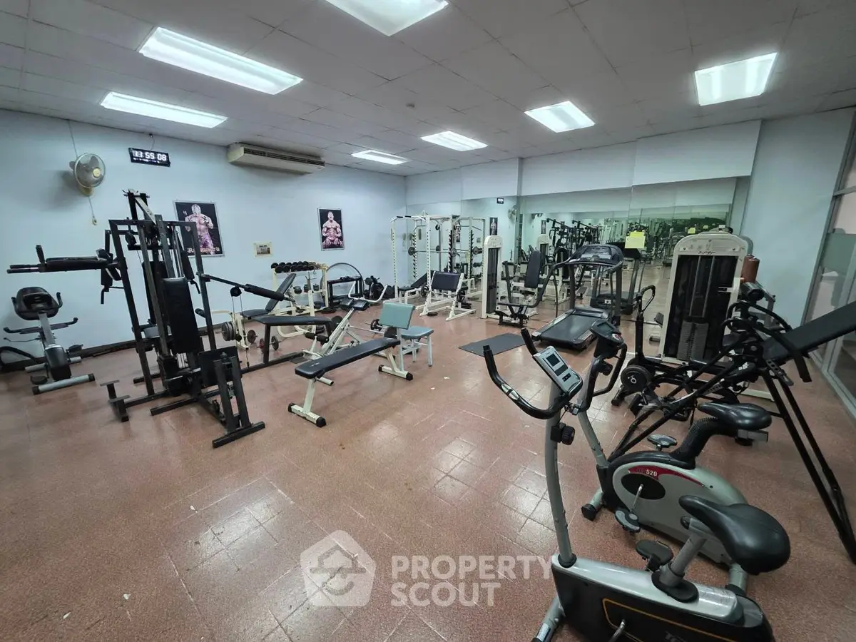 Spacious gym with modern fitness equipment in a residential building