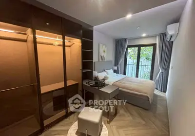 Cozy bedroom with walk-in closet and balcony view, modern design and natural light.