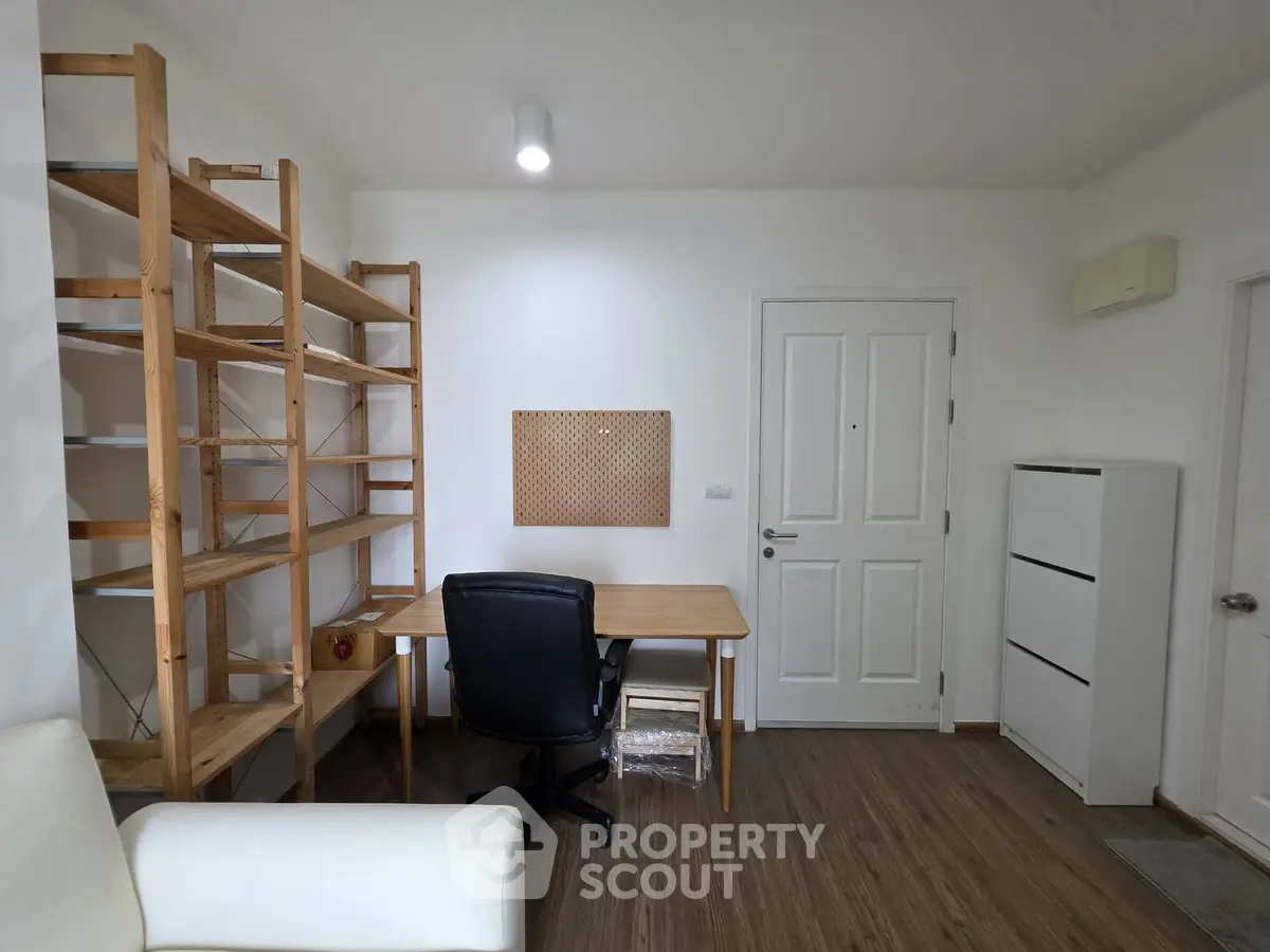Modern study room with wooden shelves and sleek desk in a minimalist design.