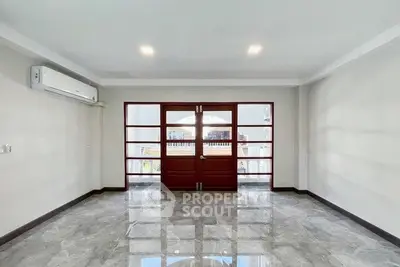 Spacious living room with modern design and large windows for natural light.