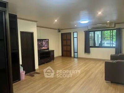 Spacious living room with modern decor and large windows for natural light.