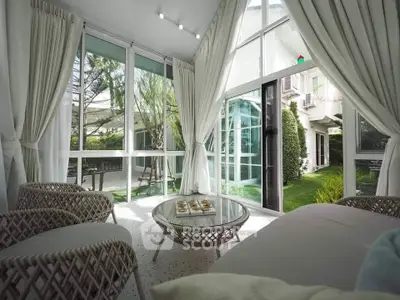 Luxurious sunlit living room with garden view and elegant decor