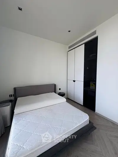 Modern minimalist bedroom with sleek wardrobe and stylish flooring
