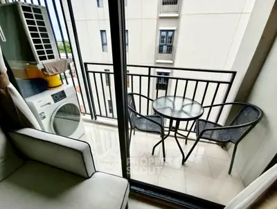 Charming balcony with seating and laundry area in modern apartment