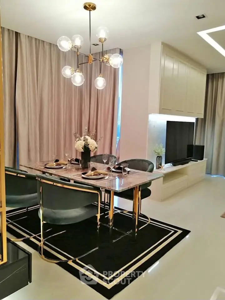 Elegant dining area with modern chandelier and stylish decor in a luxurious apartment.