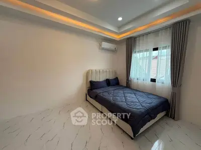 Modern bedroom with elegant lighting and cozy bed in a minimalist design.