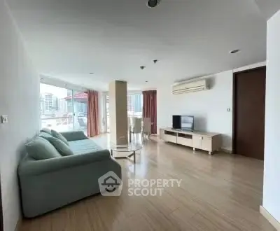 Spacious living room with modern furniture and city view, perfect for urban living.