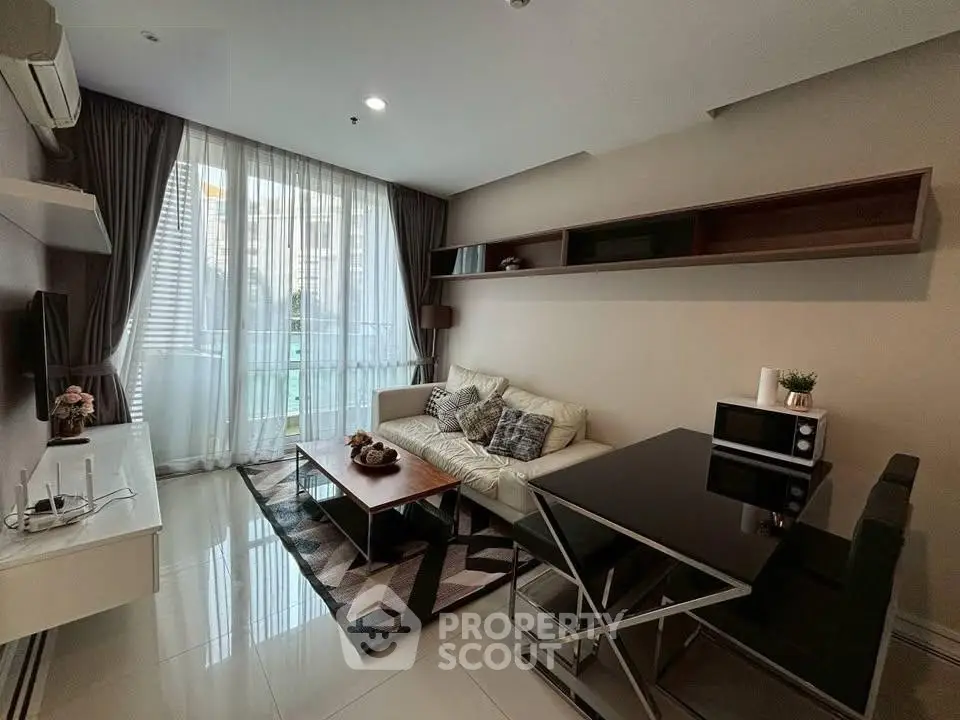 Modern living room with sleek furniture and large window for natural light.