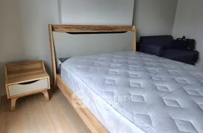 Modern bedroom with stylish wooden bed frame and cozy side table