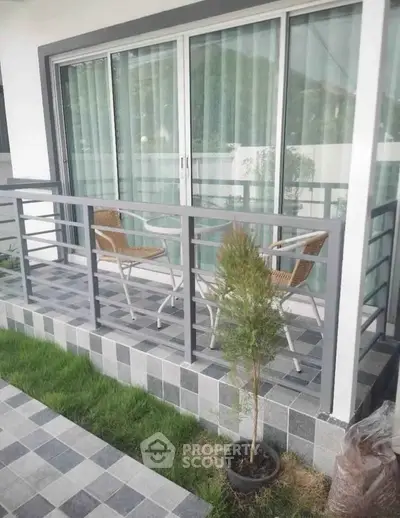 Charming balcony with modern railing and cozy seating, perfect for relaxation and enjoying outdoor views.
