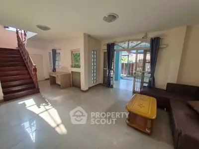 Spacious living room with natural light, modern furniture, and access to outdoor patio in a stylish home.