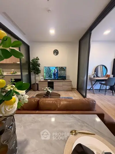 Modern living room with open layout, stylish decor, and cozy seating area