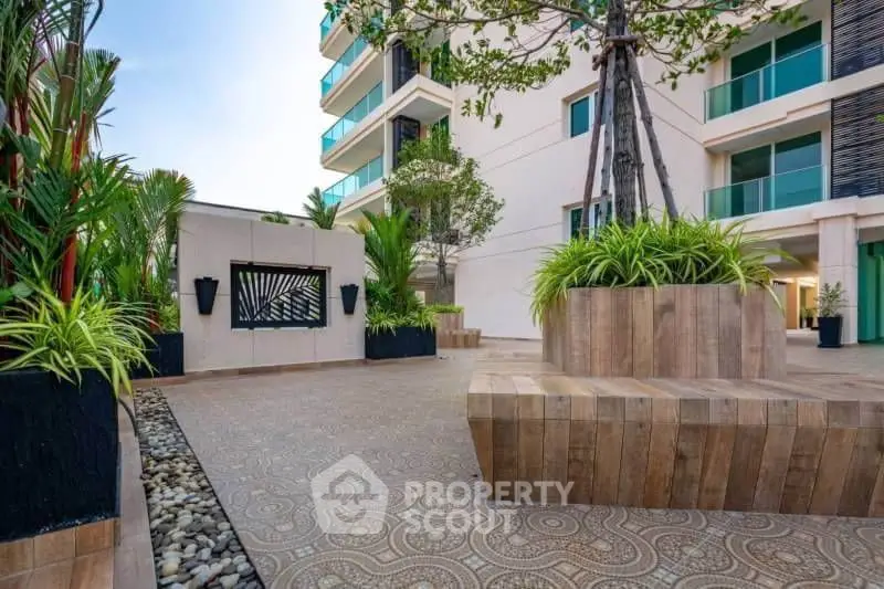 Modern apartment building with stylish outdoor seating and lush greenery