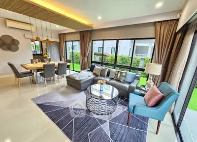 Luxurious living room with modern decor and garden view, perfect for entertaining.