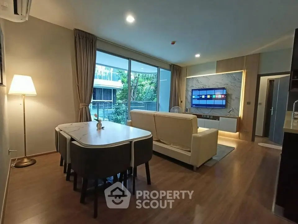 Spacious modern living room with large windows and elegant decor