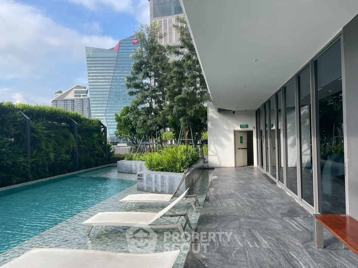 Luxurious rooftop pool area with modern design and city views, perfect for relaxation and leisure.