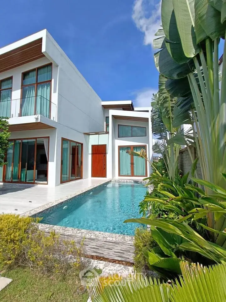 Luxurious modern villa with private pool and lush garden, perfect for tropical living.