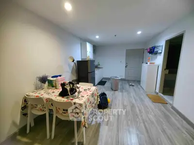 Modern open-layout kitchen and dining area with stylish decor and wooden flooring.