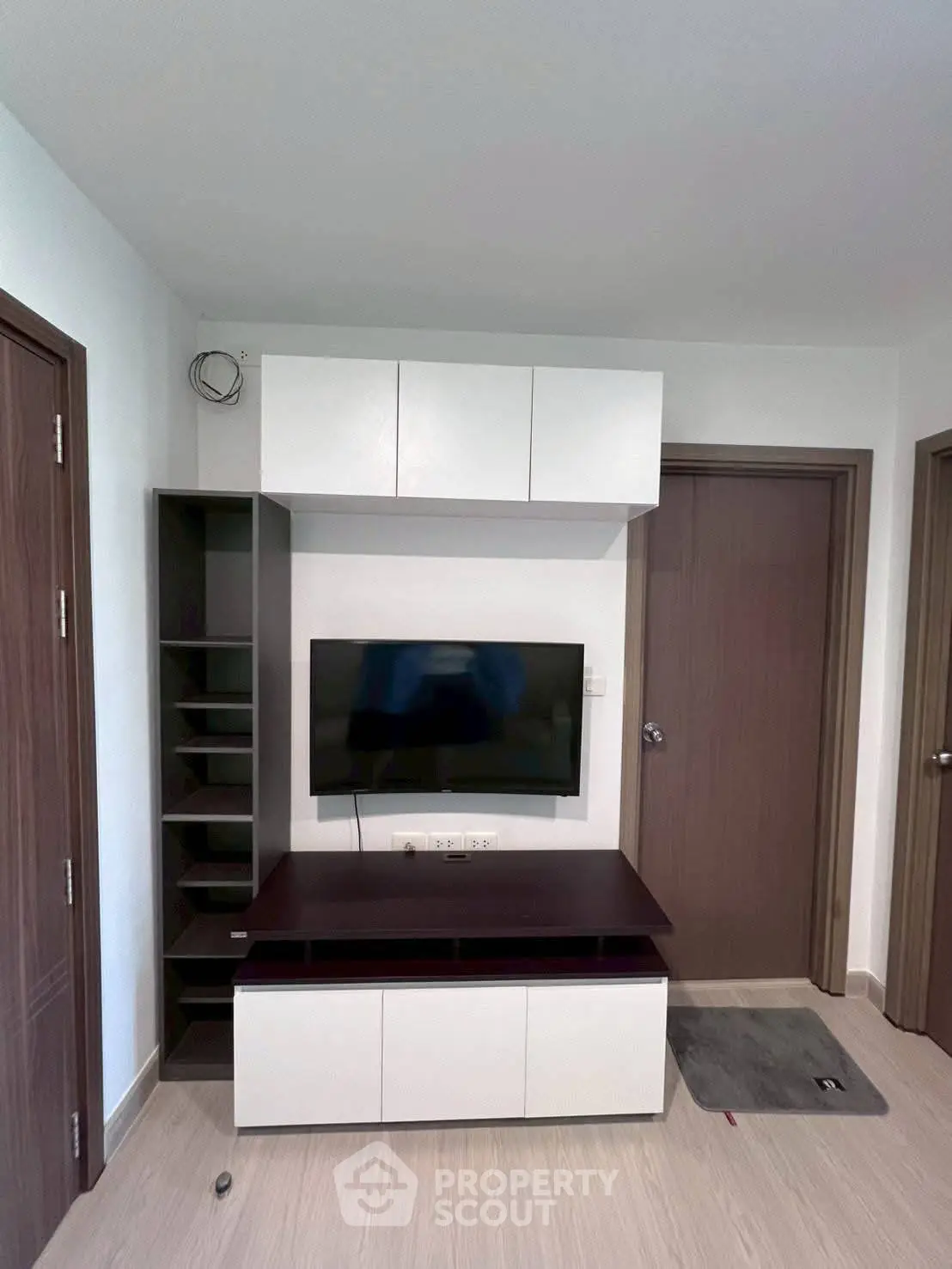 Modern living room with sleek TV unit and ample storage space