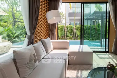 Luxurious living room with pool view and modern decor