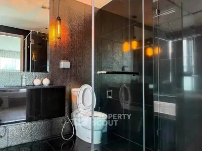 Luxurious modern bathroom with sleek black tiles and elegant lighting