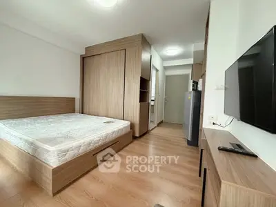 Modern bedroom with wooden flooring and built-in wardrobe in a cozy apartment.