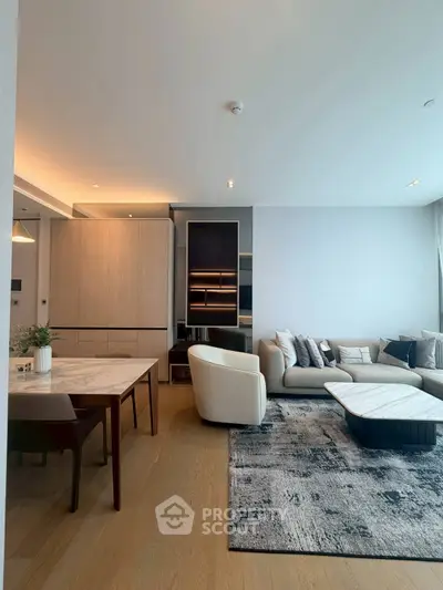 Modern living room with stylish furniture and open layout, featuring a cozy seating area and elegant dining space.