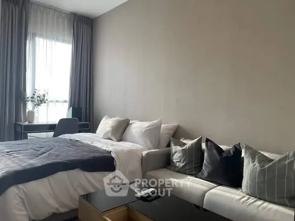 Modern bedroom with cozy sofa and natural light