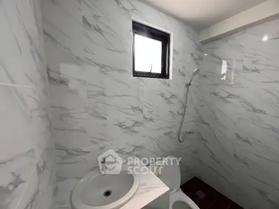 Modern bathroom with marble tiles and sleek fixtures