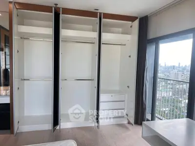 Spacious bedroom with open wardrobes and city view balcony