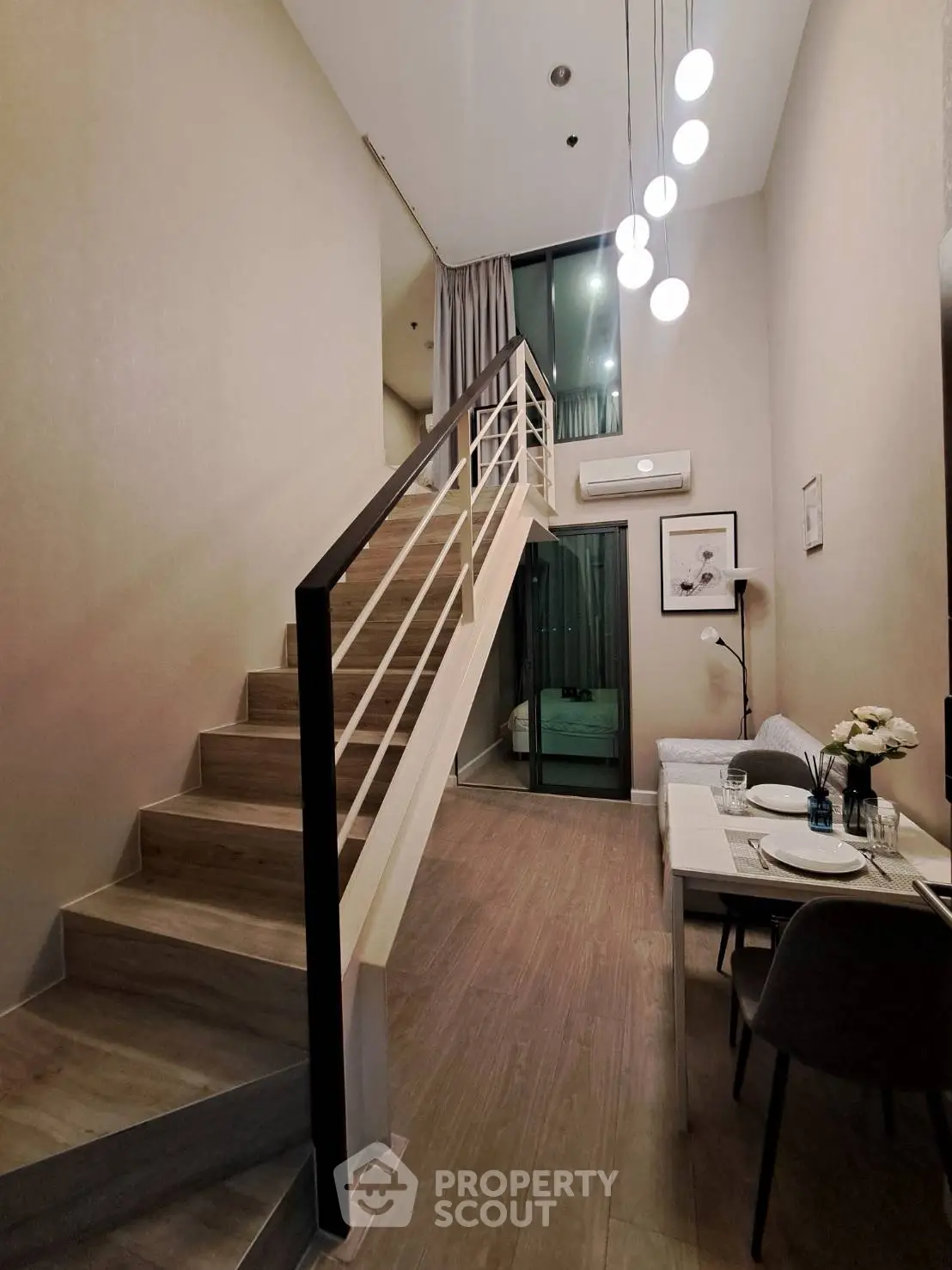 Modern loft apartment with stylish staircase and cozy dining area