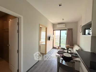 Modern apartment interior with open layout, featuring a cozy dining area and balcony with city view.