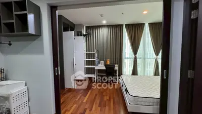 Spacious bedroom with hardwood floors and large windows in modern apartment