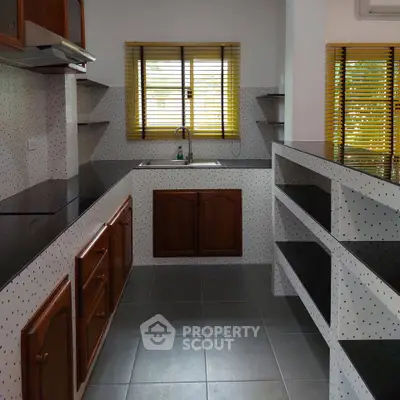 Charming kitchen with sleek countertops and ample storage space, perfect for culinary enthusiasts.